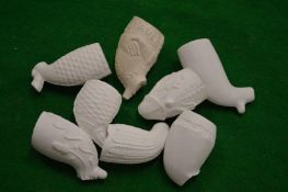 A collection of clay pipe bowls.