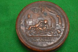 An embossed wood and tortoiseshell circular snuff box and cover.