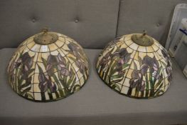 A pair of large Tiffany style ceiling shades.