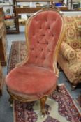A Victorian walnut framed button upholstered bedroom or nursing chair.