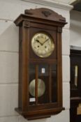 An oak cased wall clock.