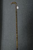 A segmented horn walking stick with silver collar.