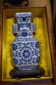A contemporary Chinese blue and white porcelain vase and stand with fitted box.