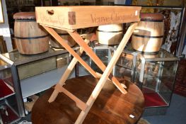 A novelty pine tray on folding stand.