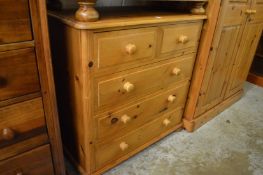 A pine chest of drawers.