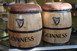 A pair of novelty barrel shaped bar stools with removable button upholstered tops.
