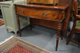 A mahogany bow front single drawer side table.
