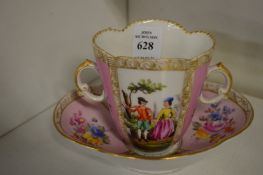 A Dresden porcelain cup and saucer.