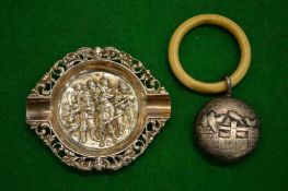 Silver rattle and a small dish.