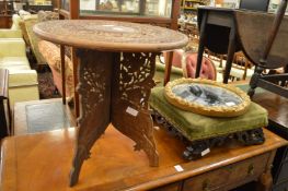 An Eastern carved hardwood table, small gilt mirror and a foot stool.