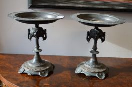 A pair of ornate cast metal tazza with porcelain portrait plaques.