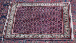 A Persian rug, dark blue ground central panel with Boteh decoration 4'10