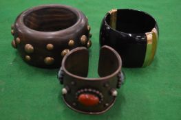 Three chunky bracelets.