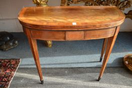 A George III mahogany and satinwood inlaid D shaped fold-over card table on tapering square legs.