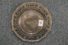 A silver presentation dish with pierced border.