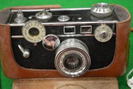 An Argus Cintar 50mm camera with a leather case together with another camera.
