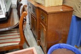 A reproduction mahogany sideboard.