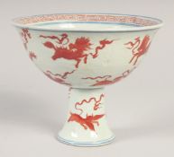 A CHINESE CORAL RED, BLUE AND WHITE PORCELAIN STEM CUP, painted with various beasts, bearing six-