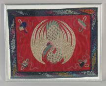 AN EARLY 20TH CENTURY CHINESE TEXTILE OF A PHOENIX, framed and glazed, textile 46cm x 36cm.