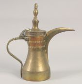AN ISLAMIC SIGNED BRASS COFFEE POT, 29.5cm high.