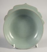 A CHINESE CELADON BOWL / CUP, with molded handle, 17.5cm wide.