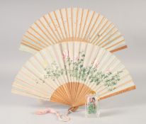 A CHINESE REVERSE PAINTED GLASS SNUFF BOTTLE, together with two wooden fans, (3).