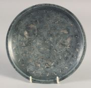 A SMALL ISLAMIC MIXED METAL DISH, decorated with fish, 16.5cm diameter.
