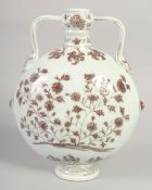 A CHINESE UNDER GLAZE RED AND WHITE TWIN HANDLE MOON FLASK, decorated with flora, 28.5cm high.
