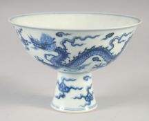 A CHINESE BLUE AND WHITE PORCELAIN STEM CUP, decorated with dragons and stylised clouds, the base