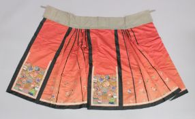 A 19TH CENTURY CHINESE SILK SKIRT, decorated with vases and flowers.