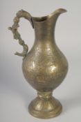 AN ISLAMIC ENGRAVED AND CHASED BRASS JUG, with figural handle, 28cm high.