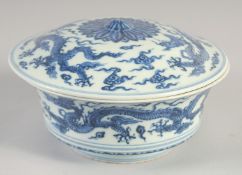 A CHINESE BLUE AND WHITE PORCELAIN BOWL AND COVER, decorated with dragons, the interior with six-