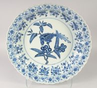 A LARGE CHINESE BLUE AND WHITE PORCELAIN DISH, painted with a bird and fruit, 41.5cm diameter.
