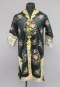 A 20TH CENTURY CHINESE FEMALE ROBE, decorated with flowers and lucky objects.