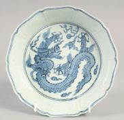 A CHINESE BLUE AND WHITE PORCELAIN PETAL-FORM DRAGON BOWL, six-character mark to base, 19cm wide.