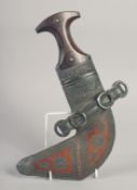 AN OMANI JAMBIYA DAGGER WITH SILVER OVERLAID SCABBARD and inlaid handle, 30cm long.
