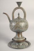 AN ISLAMIC SILVER OVERLAID BRASS EWER, on stand, with panels of calligraphy, 31cm high overall.