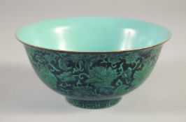 A CHINESE BLACK GLAZE PORCELAIN BOWL, decorated with flowers, the interior with turquoise glaze,