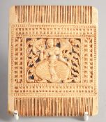 A DECORATIVE COMB in the South Indian style, with a central panel of a dancing lady. 9cm x 7.5cm