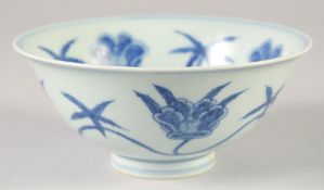 A CHINESE BLUE AND WHITE PORCELAIN BOWL, decorated with large flower heads, six-character mark to