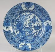 A 17TH CENTURY KANGXI PERIOD BLUE AND WHITE PORCELAIN PLATE, painted with birds and flora, the