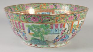 A LARGE CHINESE CANTON FAMILLE ROSE PORCELAIN PUNCH BOWL, painted with panels of figures and further