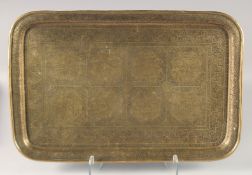 A LARGE 19TH CENTURY PERSIAN QAJAR ENGRAVED BRASS TRAY, 58.5cm x 38cm.