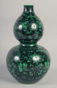 A CHINESE BLACK GROUND DOUBLE GOURD VASE, decorated with peaches, bats and scrolling vine, 31cm
