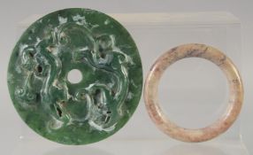 A CHINESE JADE DISK, with calligraphy and lion dogs, together with a hardstone bangle, (2).