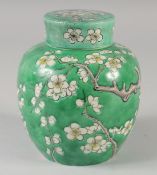 A 19TH CENTURY CHINESE GREEN GROUND PRUNUS GINGER JAR, (af), 15cm high.