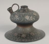 AN 18TH CENTURY INDIAN BIDRI SILVER INLAID HUQQA BASE, with foliate motifs, 20.5cm diameter.
