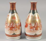 A PAIR OF JAPANESE PORCELAIN SAKE BOTTLES, each with character mark to base, 17cm high.