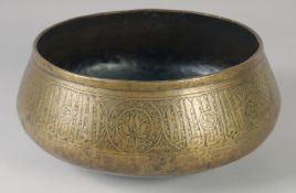 A FINE 14TH CENTURY MAMLUK RASULID BRASS BASIN, with engraved calligraphic panels, 26cm diameter.