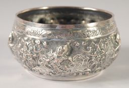 A BURMESE EMBOSSED SILVER BOWL, with relief decoration of figures, weight 155g, 12cm diameter.